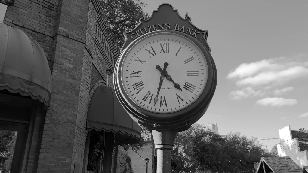 Still from Return of the Repressed (2023) by Mazyar Mahan: an old street clock against the sky.